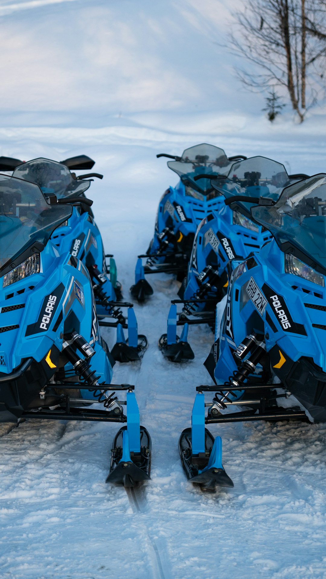 Services several-blue-snowmobiles-parked-in-the-snow-oxzmzqozema